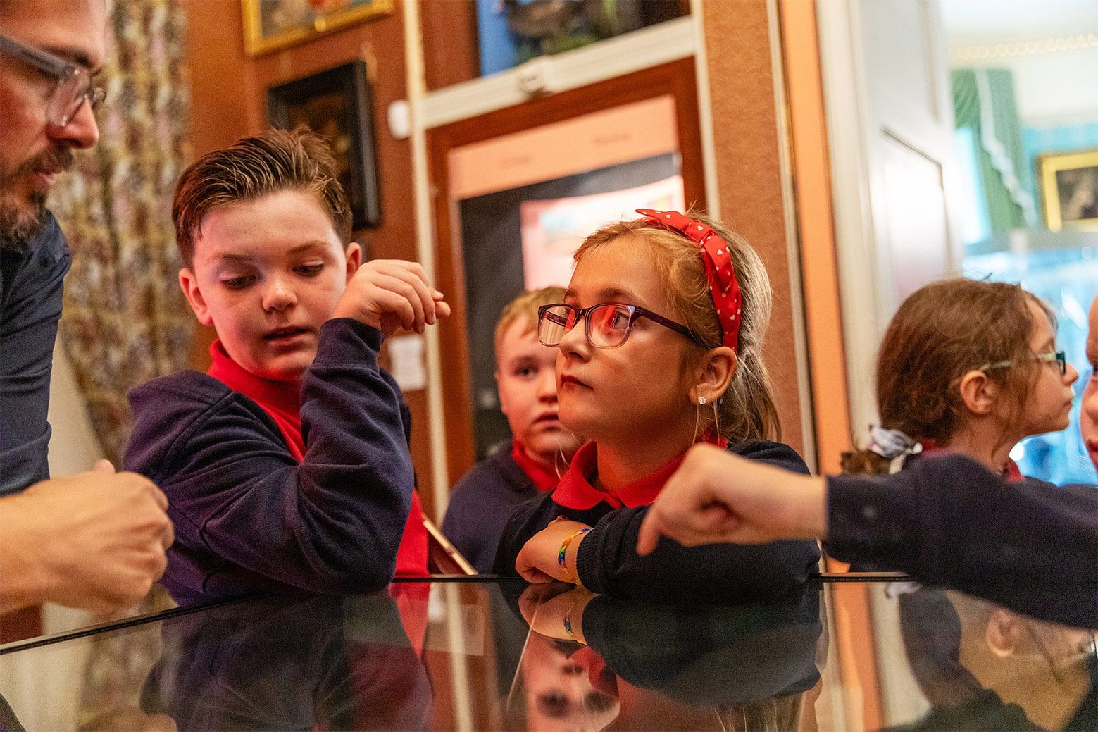 Children wearing school red and black school uniform.jpg